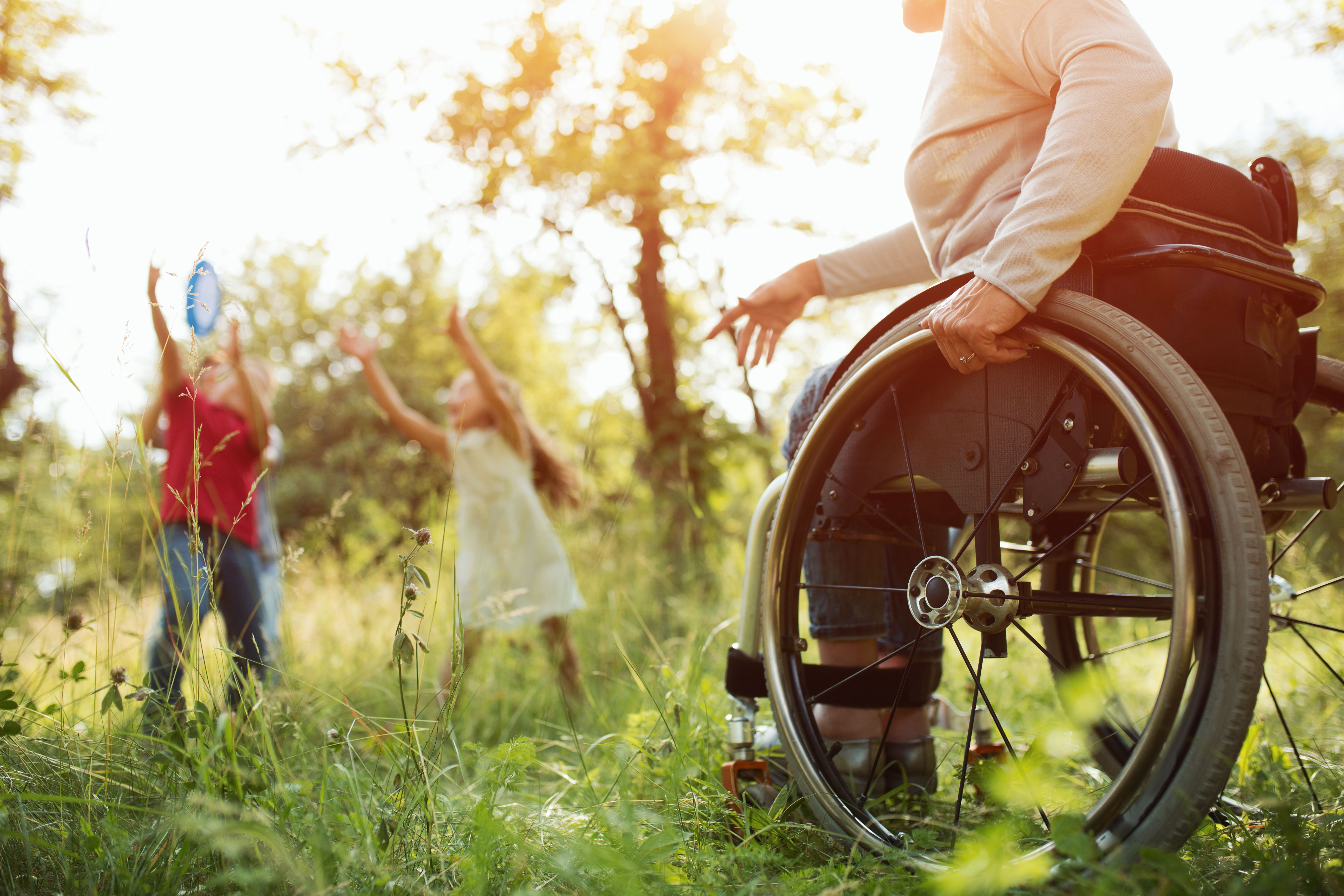 Paraplegic Woman Tightly Hangs Pushrim Wheelchair While Throwing Frisbee Her Children Park Detailed Look Wheelchair