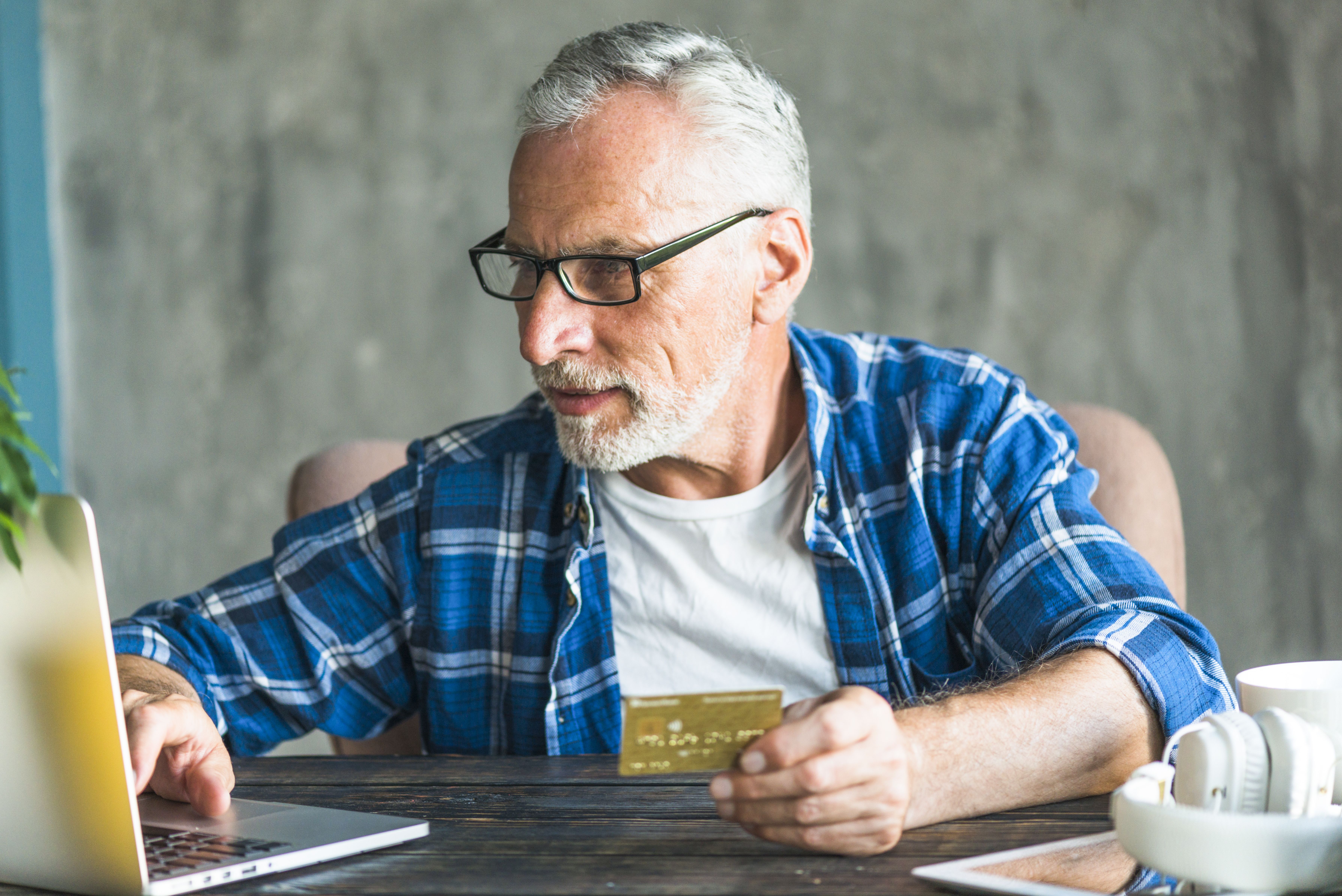 Senior Man Doing Online Shopping Through Laptop