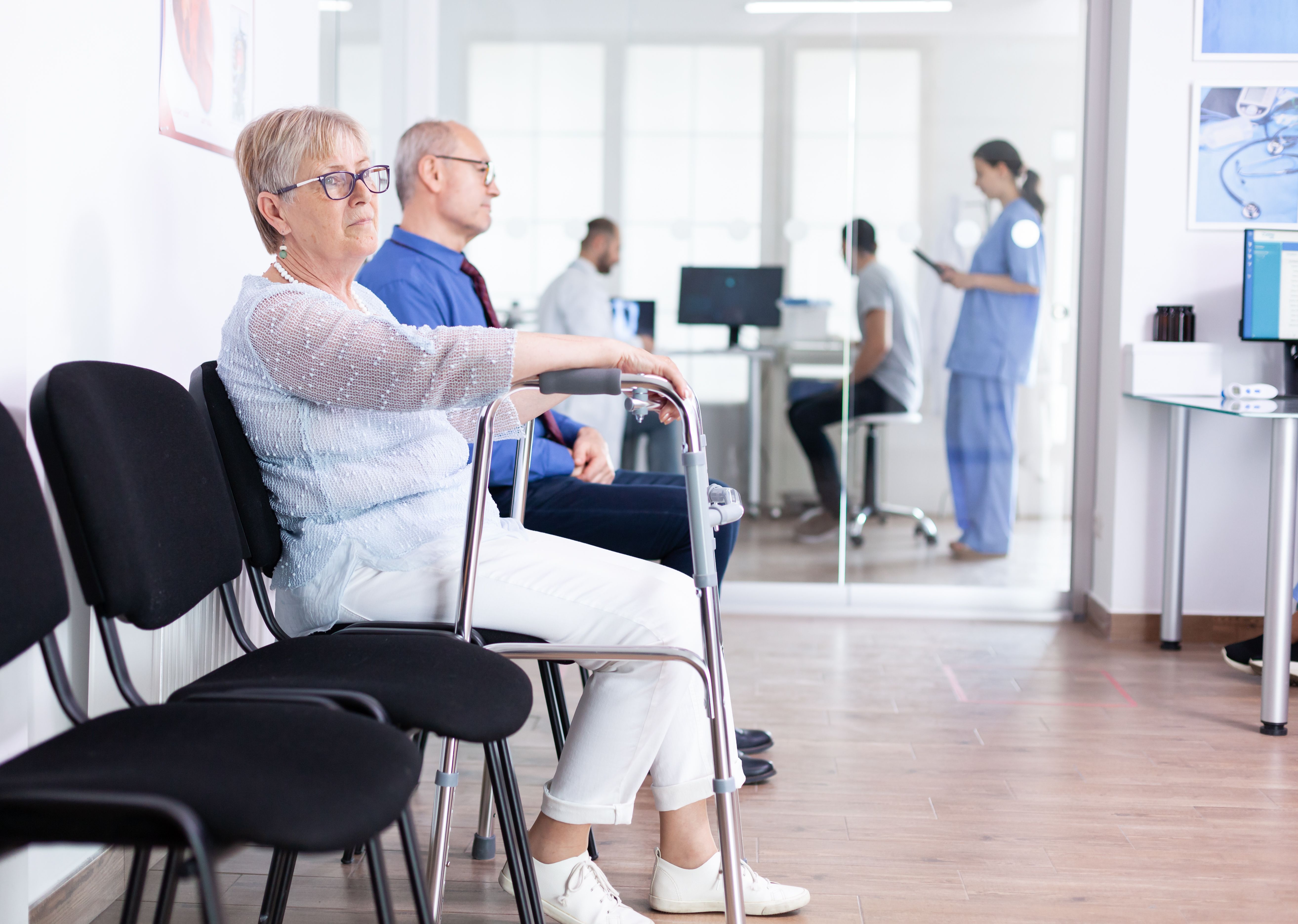 Senior Woman With Walking Frame Hospital Waiting Room Rehabilitation Treatment