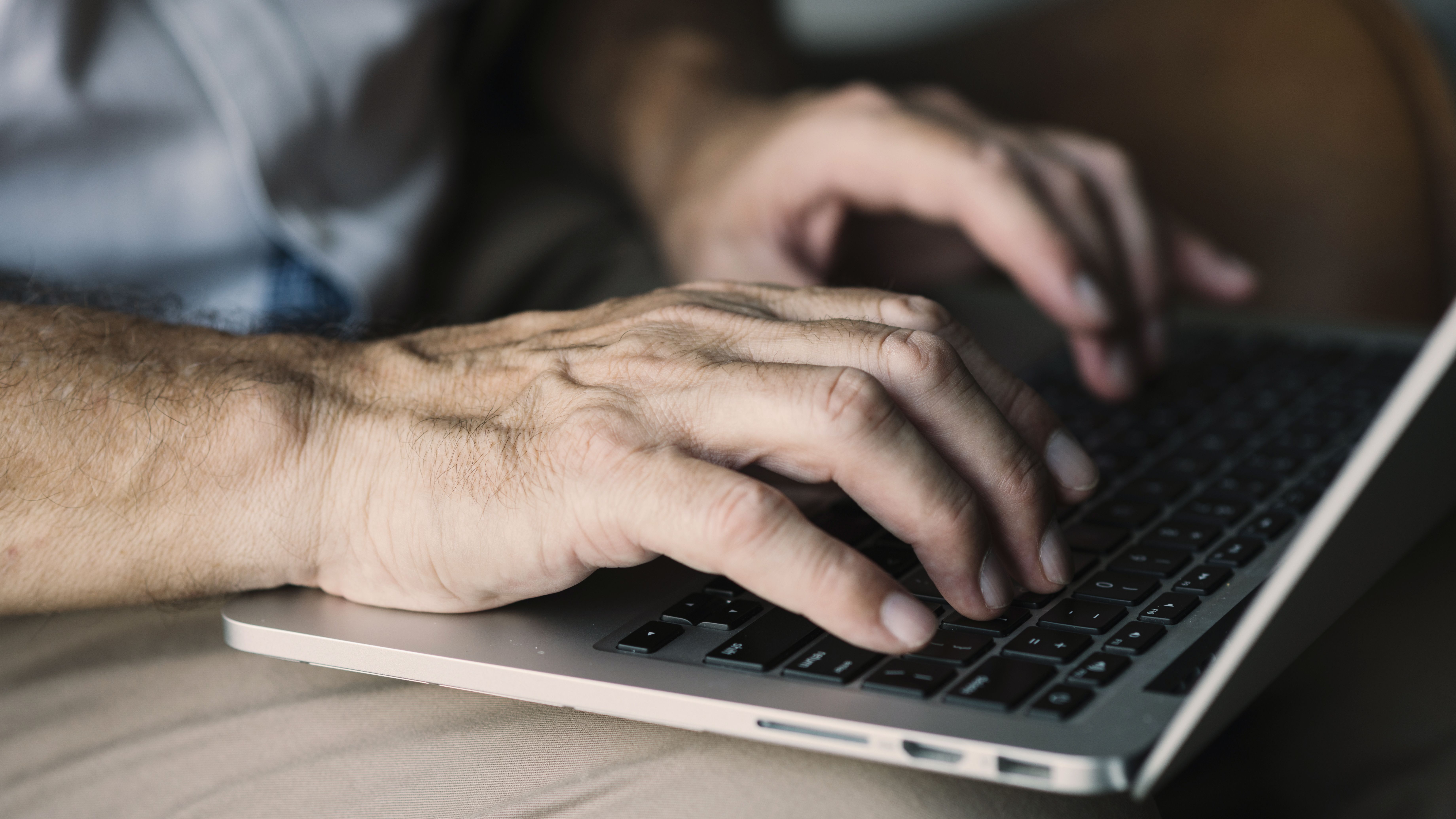 Elderly Man S Hand Typing Laptop